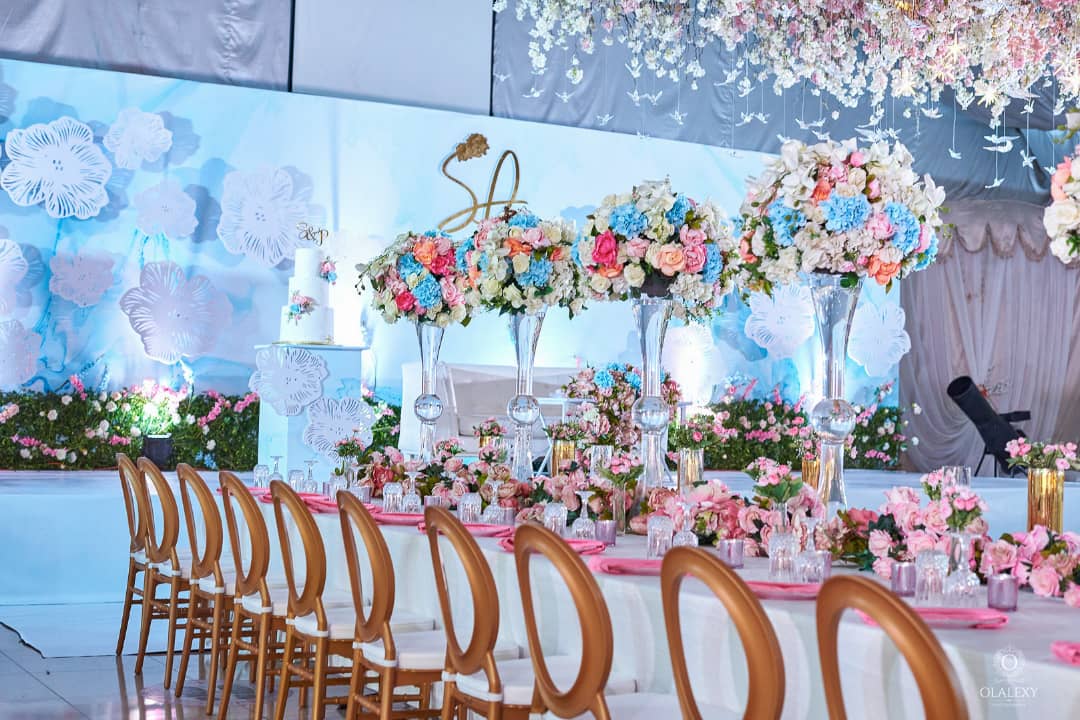 Decorated event table with floral arrangements and chairs in a formal setting in Lagos Nigeria
